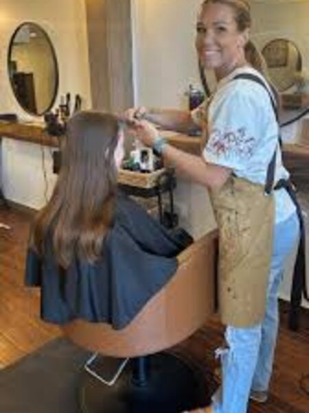 Alex working with a client at Copper Pig Cuts